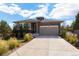 House exterior showcasing a two-car garage and well-maintained landscaping at 25146 E 1St Ave, Aurora, CO 80018