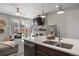 Modern kitchen with island, stainless steel appliances, and double sink at 25146 E 1St Ave, Aurora, CO 80018