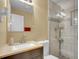 Bathroom features a stone countertop, sink with faucet, toilet, and a stand up shower with glass door at 7751 Niagara St, Commerce City, CO 80022