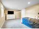 Spacious carpeted bedroom with TV and neutral colors at 7751 Niagara St, Commerce City, CO 80022