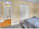 Bedroom featuring closet and ensuite bathroom access at 7751 Niagara St, Commerce City, CO 80022