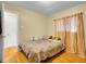 Cozy bedroom with wood floors, neutral walls, and a comfortable bed with soft bedding at 7751 Niagara St, Commerce City, CO 80022