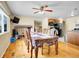 Dining room features a large table, ceiling fan, and access to the kitchen at 7751 Niagara St, Commerce City, CO 80022