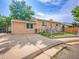 Charming single-story home with a fenced front yard and a long driveway with ample parking at 7751 Niagara St, Commerce City, CO 80022