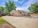 The property has a large concrete parking pad and easy access to the backyard at 7751 Niagara St, Commerce City, CO 80022