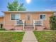 Charming home with a small porch and manicured front lawn, situated in a friendly neighborhood at 7751 Niagara St, Commerce City, CO 80022