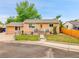 Charming single-Gathering home featuring a fenced yard and inviting front porch at 7751 Niagara St, Commerce City, CO 80022