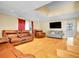 Open living room with hardwood floors, skylight, and comfortable seating arrangements at 7751 Niagara St, Commerce City, CO 80022