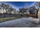 Spacious backyard showcasing a concrete patio and natural landscape, offering outdoor living and potential at 8965 Jellison Ct, Broomfield, CO 80021