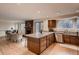 Open concept kitchen with granite counters and a brick fireplace nearby creates a warm, inviting living space at 8965 Jellison Ct, Broomfield, CO 80021