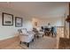 Bright living room featuring neutral decor, hardwood floors, and adjacent dining area, creating a welcoming space at 8965 Jellison Ct, Broomfield, CO 80021