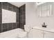 Nicely tiled bathroom with a tub-shower, toilet, vanity, and mirrored medicine cabinet at 1272 Bluebird St, Brighton, CO 80601