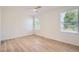 Bright bedroom featuring two windows, a ceiling fan, and laminate flooring at 1272 Bluebird St, Brighton, CO 80601