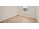 Bedroom features laminate floors, a window with blinds, and white walls at 1272 Bluebird St, Brighton, CO 80601