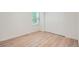 Bedroom features laminate floors, a window with blinds, a closet, and white walls at 1272 Bluebird St, Brighton, CO 80601