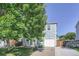 Charming two-story home featuring blue siding, a one car garage and mature trees at 1272 Bluebird St, Brighton, CO 80601