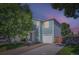 Charming two-story home featuring blue siding, a one car garage and mature trees at 1272 Bluebird St, Brighton, CO 80601