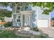 Inviting front entrance with a covered porch and well-maintained landscaping and blue siding at 1272 Bluebird St, Brighton, CO 80601