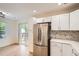 Kitchen featuring stainless steel refrigerator and sliding door with access to outdoor deck at 1272 Bluebird St, Brighton, CO 80601
