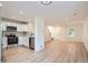 Spacious living room with a modern kitchen, ample natural light, and laminate flooring at 1272 Bluebird St, Brighton, CO 80601