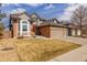 Beautiful two-story home boasting a three-car garage and a neatly landscaped front yard at 8901 Forrest Dr, Highlands Ranch, CO 80126