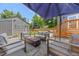 Outdoor patio features a fire pit, modern seating, and a large patio umbrella, perfect for relaxation and entertainment at 1738 S Franklin St, Denver, CO 80210