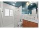 Modern bathroom features white tiles, a stylish vanity, and a walk-in shower at 1738 S Franklin St, Denver, CO 80210