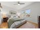 Calm main bedroom features hardwood floors, a ceiling fan, and two bright windows at 1738 S Franklin St, Denver, CO 80210