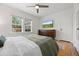 Bright main bedroom features hardwood floors, a ceiling fan, and two bright windows at 1738 S Franklin St, Denver, CO 80210