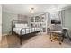 Cozy bedroom features built-in shelving, a neutral color scheme, and a comfortable work space at 1738 S Franklin St, Denver, CO 80210