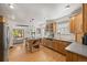 Bright kitchen with island, stainless steel appliances, wood cabinets, and hardwood floors at 1738 S Franklin St, Denver, CO 80210