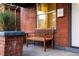 Cozy front porch featuring a wooden bench and classic brick detailing at 4150 Raritan St, Denver, CO 80211