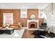 Bright living area with exposed brick, elegant fireplace, and comfortable seating at 4150 Raritan St, Denver, CO 80211