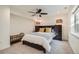 Comfortable main bedroom featuring a ceiling fan, bedside lamps, and closet for easy organization at 6187 Terry Way, Arvada, CO 80403