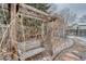 Backyard view featuring a pergola with a bench covered in vines and snow at 2152 Grant St, Longmont, CO 80501