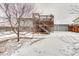 Backyard view featuring a deck and a snow-covered yard at 2152 Grant St, Longmont, CO 80501