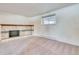 Basement featuring carpeted floors and a fireplace with a decorative mantle at 2152 Grant St, Longmont, CO 80501