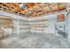 Unfinished basement with concrete floor, pegboard, exposed wood ceiling, and shelving at 2152 Grant St, Longmont, CO 80501