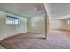 Unfinished basement featuring carpeted floors, neutral walls, and a large window at 2152 Grant St, Longmont, CO 80501