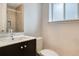 Bathroom featuring a sleek vanity with a shower and frosted window providing natural light at 2152 Grant St, Longmont, CO 80501