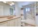 Well-lit bathroom featuring a large vanity, updated lighting and tiled shower-tub combo at 2152 Grant St, Longmont, CO 80501