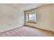 Bright bedroom featuring a window with a built-in seat and a door to the outside at 2152 Grant St, Longmont, CO 80501