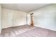 Neutral bedroom featuring a large window, neutral walls, and a closet at 2152 Grant St, Longmont, CO 80501