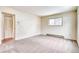 Cozy bedroom showcasing neutral walls, carpet, and a window, offering comfort and natural light at 2152 Grant St, Longmont, CO 80501