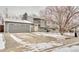 Well-maintained gray home with a large driveway and a charming yellow front door at 2152 Grant St, Longmont, CO 80501