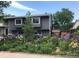 Charming two-story home boasts a lush front yard with colorful flowers at 2152 Grant St, Longmont, CO 80501