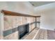 Close up of the fireplace in the basement, featuring tile surround and dark wood mantel at 2152 Grant St, Longmont, CO 80501