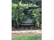 Relaxing garden bench covered by pergola with lush grape vines and rock path at 2152 Grant St, Longmont, CO 80501