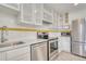 Well-equipped kitchen with stainless steel appliances, white cabinetry, and ample counter space at 2152 Grant St, Longmont, CO 80501