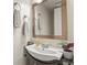 Clean bathroom features a sleek vanity with modern faucet, complemented by neutral tones and a decorative mirror at 10310 E Jewell Ave # 55, Aurora, CO 80247